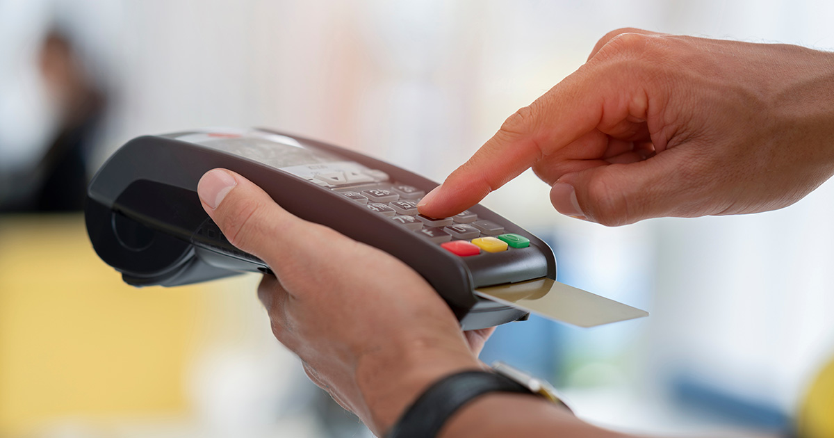 Person using a POS system processing a credit card payment