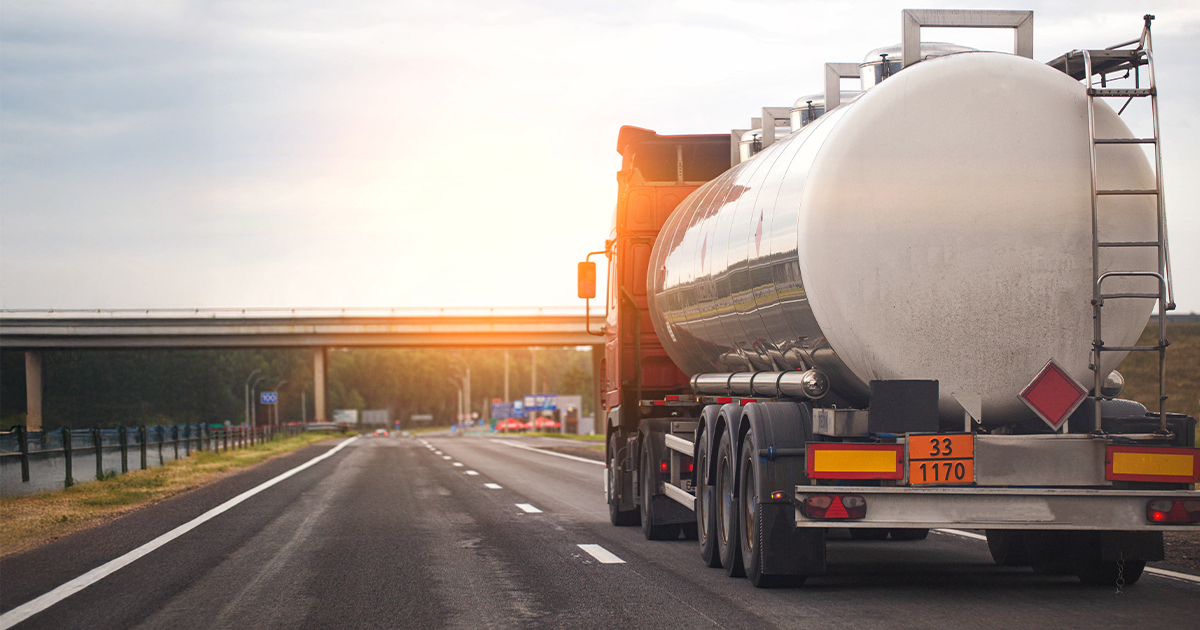 An oil truck driving on the highway.